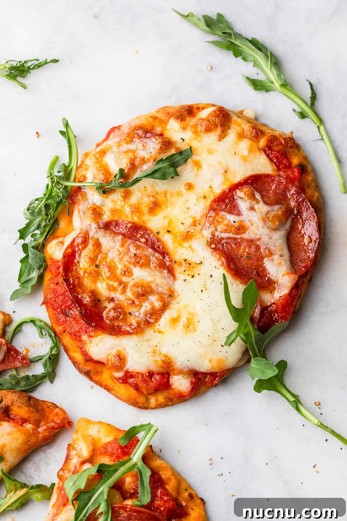 Crispy Air Fryer Naan Pizza Recipe for Quick Weeknight Meals 8 The completed air fryer naan pizza with some arugula.