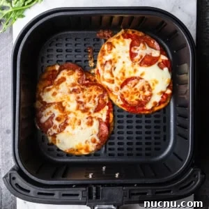 Crispy Air Fryer Naan Pizza Recipe for Quick Weeknight Meals 9 Air fryer naan pizza in the air fryer basket.