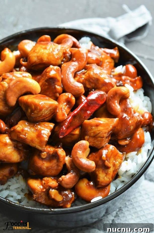Instant Pot Cashew Chicken served on white jasmine rice in a black bowl