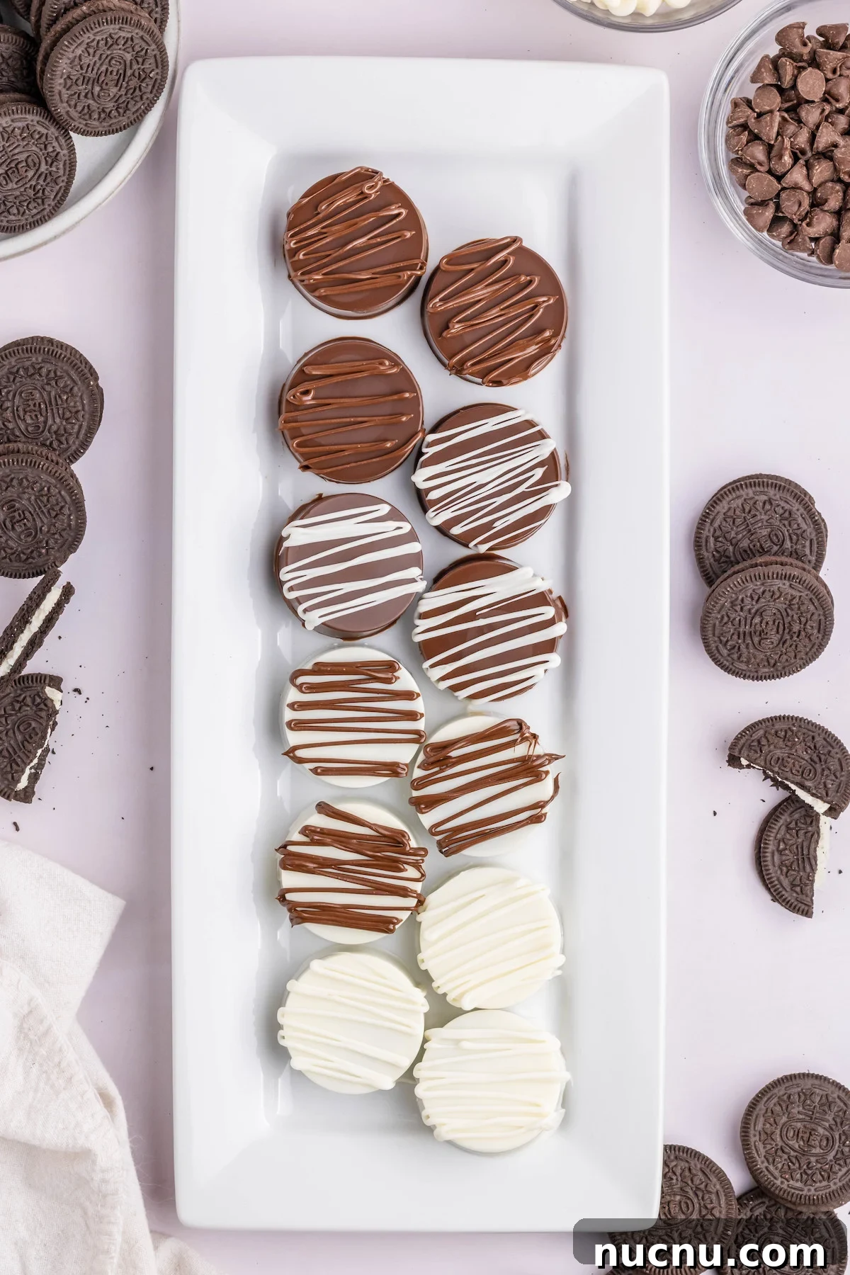 Ultimate Chocolate-Covered Oreos Recipe for Perfect Treats 2 Overhead view of a serving platter filled with white and milk chocolate covered Oreo cookies.