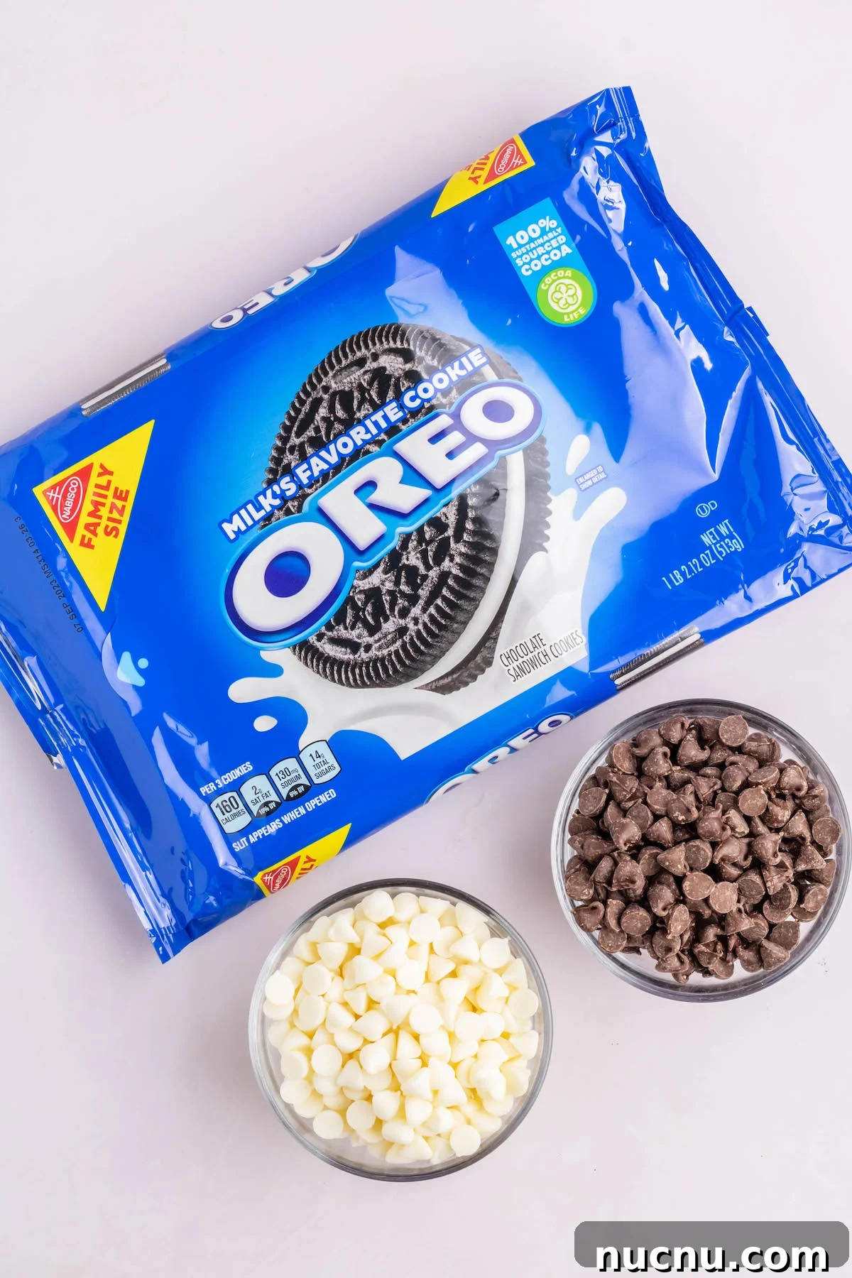 Ultimate Chocolate-Covered Oreos Recipe for Perfect Treats 4 A package of Oreo cookies next to prep bowls of milk chocolate chips and white chocolate chips.