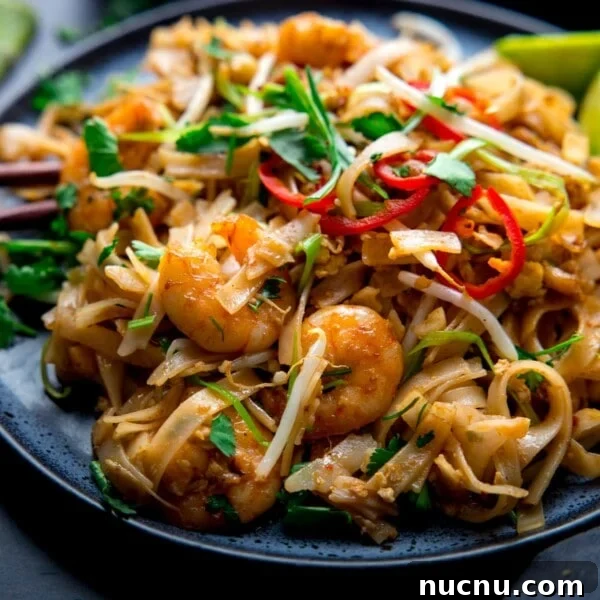 Authentic Thai Green Chicken Curry Recipe (Step-by-Step) 9 Prawn Pad Thai on a dark plate