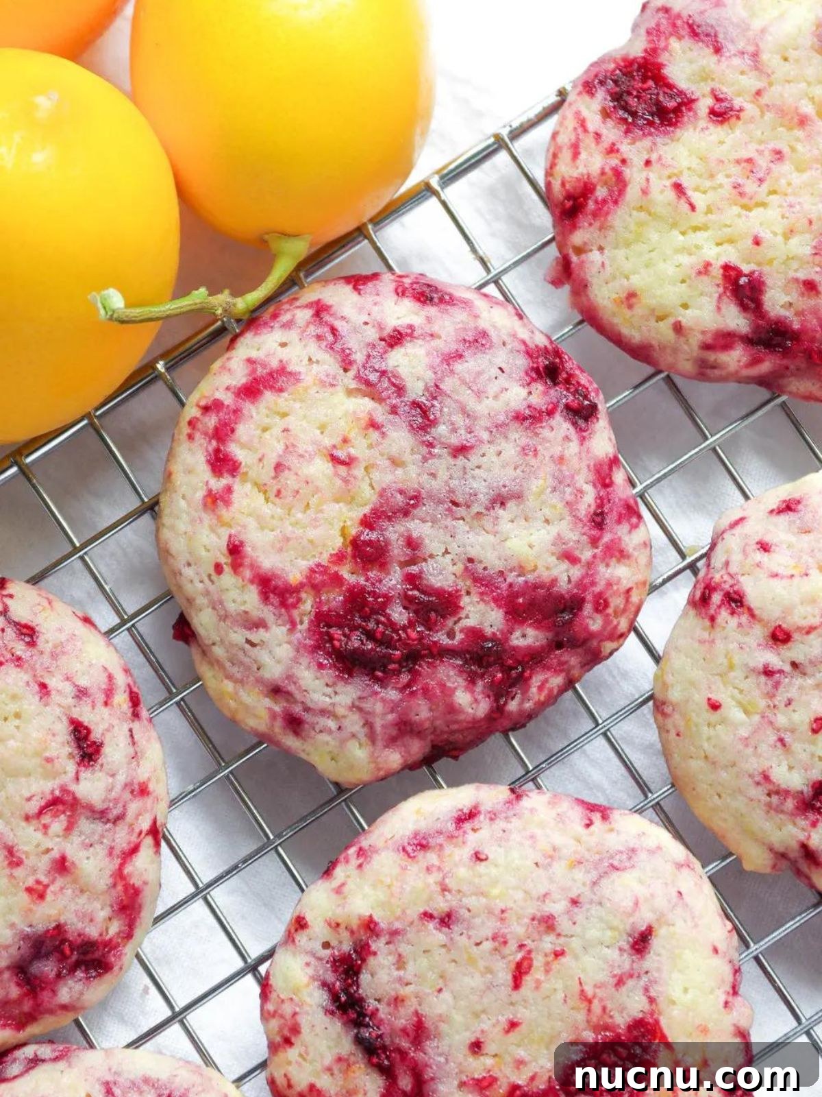 25 Unique Cookie Recipes You’ll Want to Bake Now 9 lemon raspberry cookies on cooling rack.