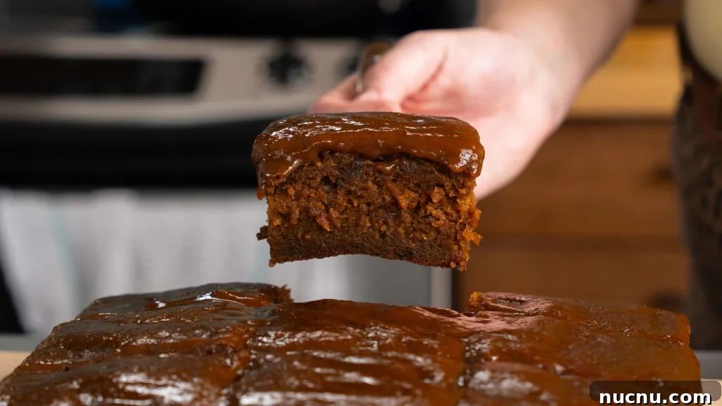 Pumpkin Sticky Toffee Pudding with Butterscotch Sauce Recipe 6 A piece of pumpkin sticky toffee pudding cake being served from a pan.