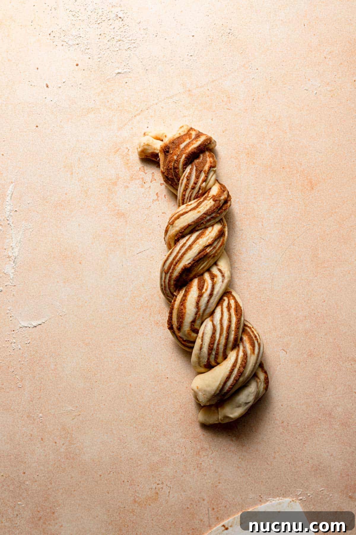 Twist the two sides around each other.