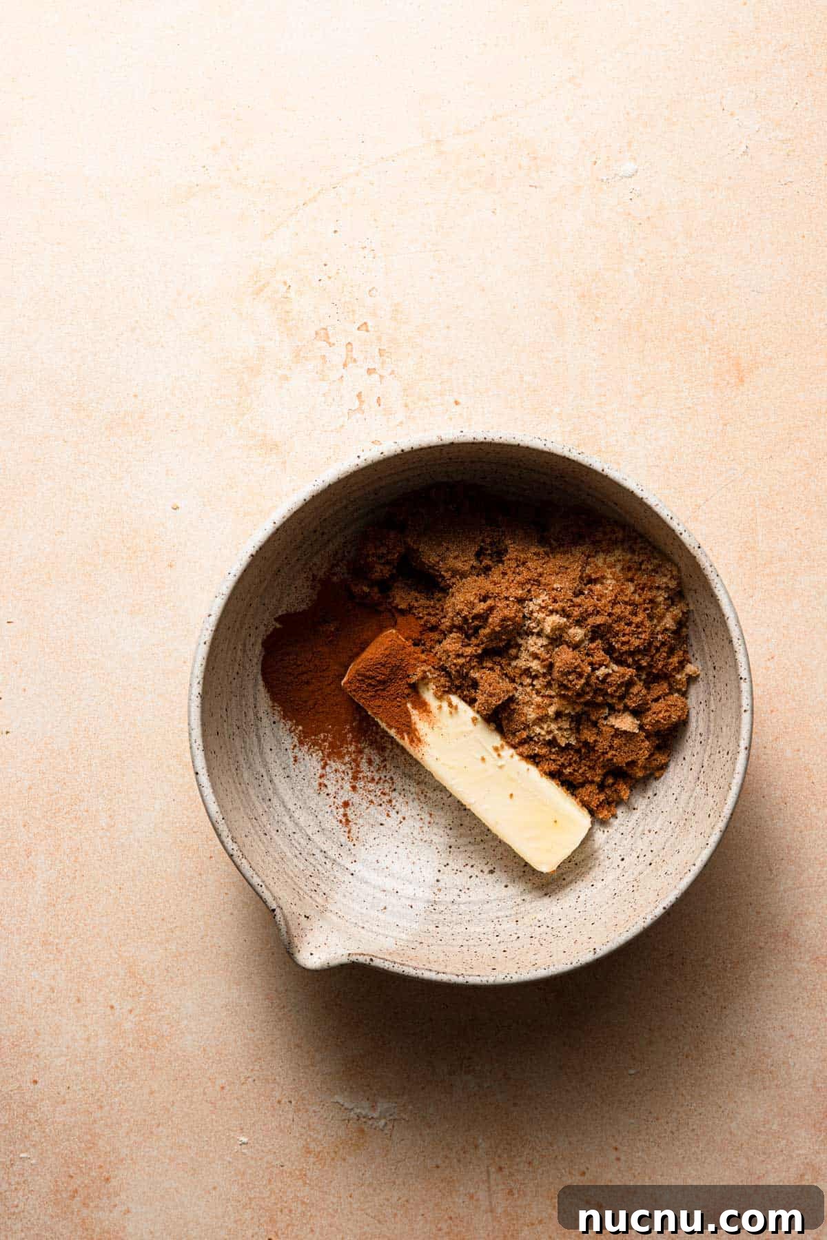 A bowl with cinnamon sugar and butter.