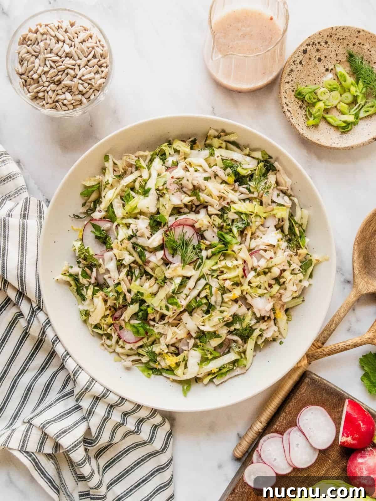 Lemon Sumac Coleslaw (No Mayo) — Tangy, Fresh Side Dish 2 No mayo coleslaw with radish, fresh herbs in a lemon sumac dressing in a bowl.