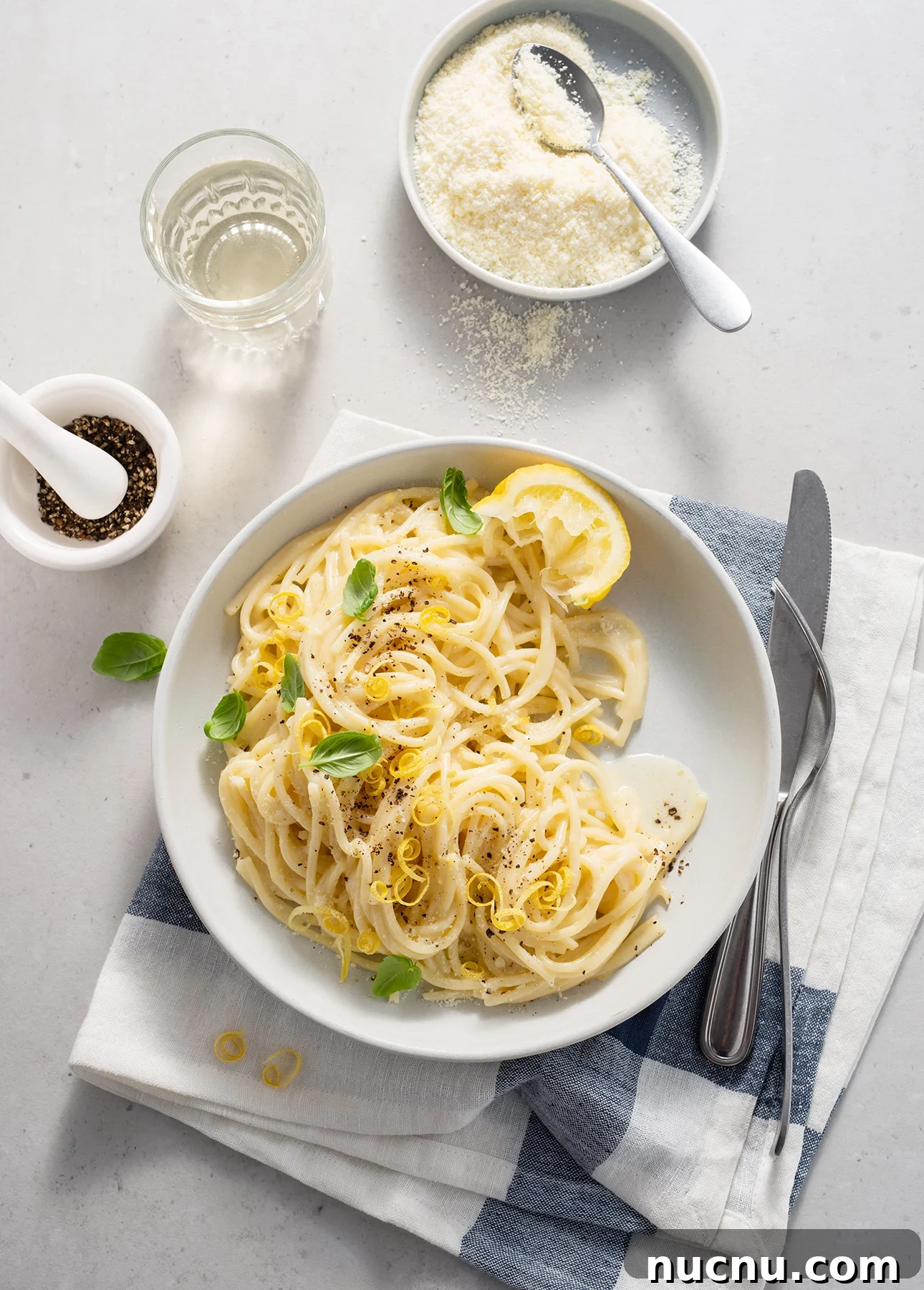 Creamy Lemon Spaghetti Recipe: Zesty, Silky Pasta in 20 Minutes 9 A plate of creamy spaghetti al limone garnished with lemon slices, basil, and black pepper