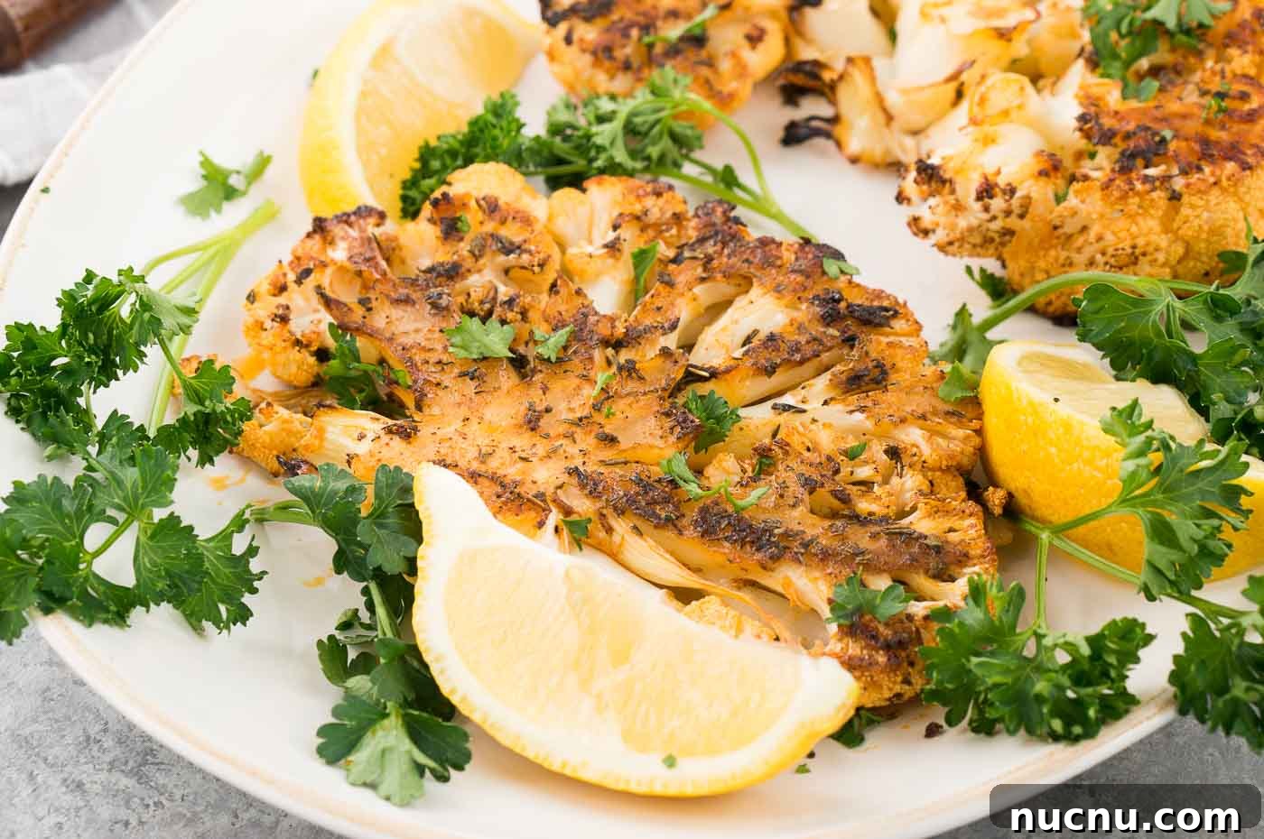 Roasted Cauliflower Steaks with Garlic and Herb Butter 3 close up image of cauliflower steaks