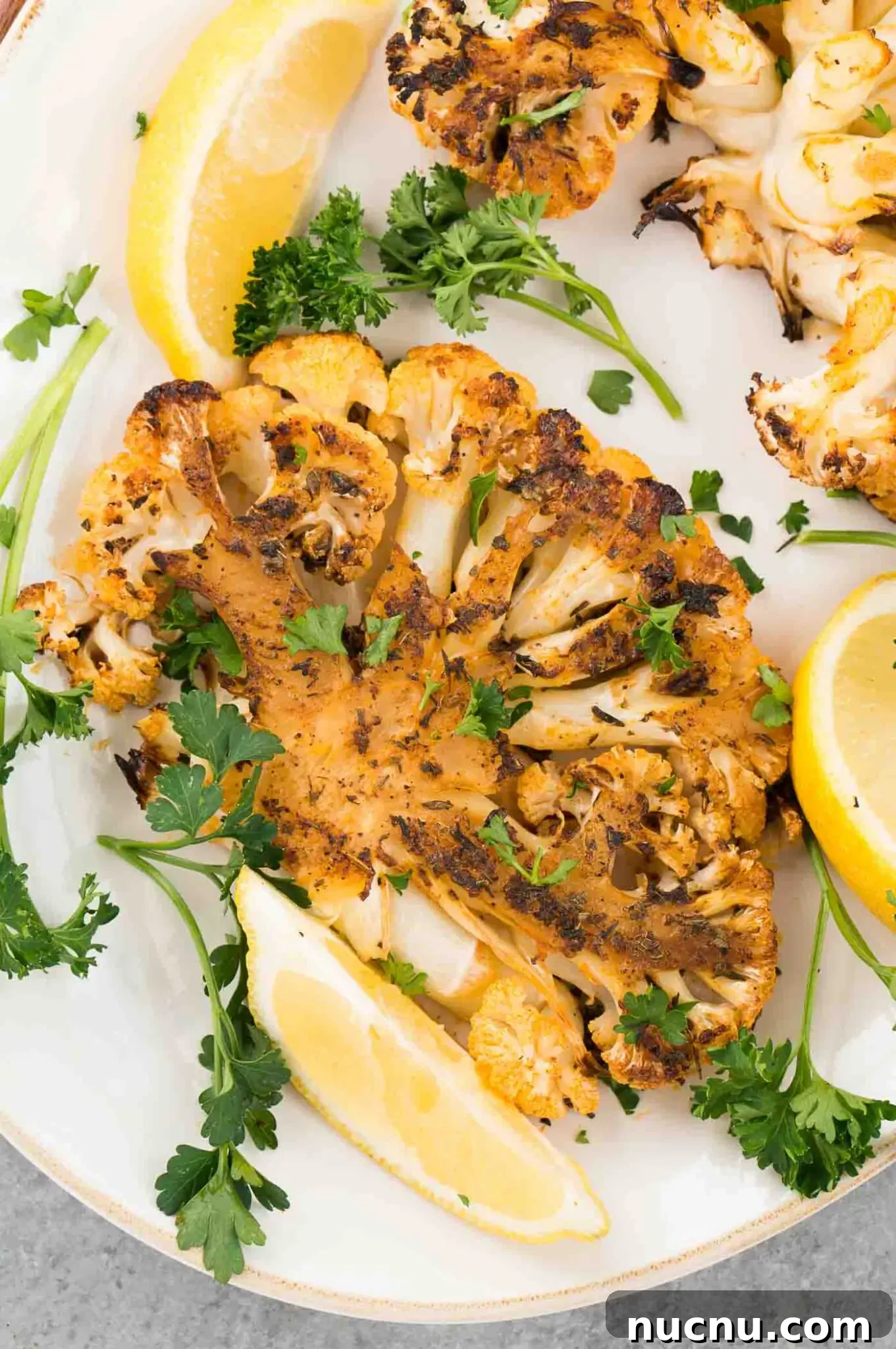 Roasted Cauliflower Steaks with Garlic and Herb Butter 8 close up image of cauliflower steak on a platter