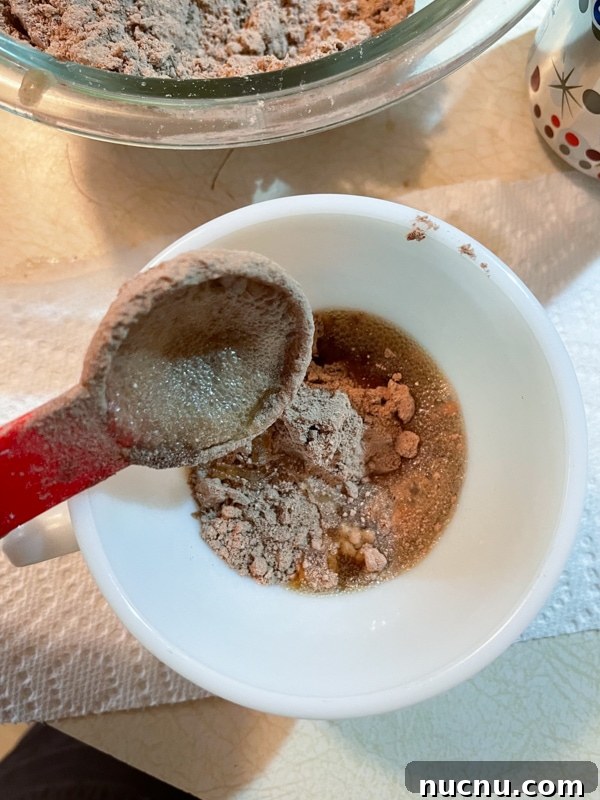 Quick Chocolate Mug Cake from Cake Mix in Minutes 5 Adding liquid to mug cake