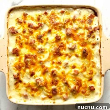 Creamy Scalloped Potatoes with Ham Casserole Recipe 9 overhead shot of scalloped potatoes and ham after baking; cheese is golden brown.