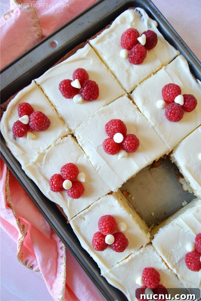 White Chocolate Raspberry Layer Cake Recipe for Celebrations 3 a pan of white chocolate raspberry cake slices