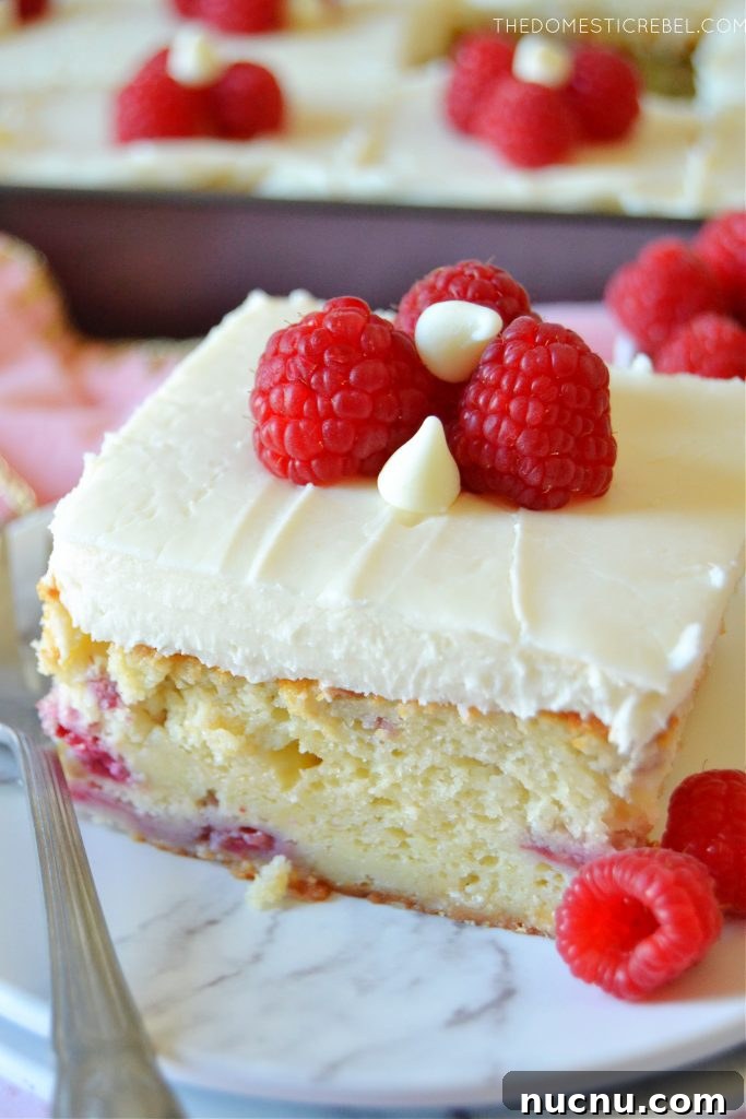 White Chocolate Raspberry Layer Cake Recipe for Celebrations 4 slice of white chocolate raspberry cake on a white plate