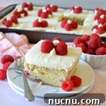 White Chocolate Raspberry Layer Cake Recipe for Celebrations 6 a square slice of white chocolate raspberry cake