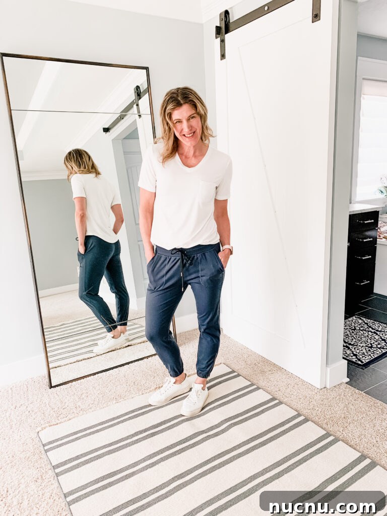 a woman in navy blue joggers and a white t shirt