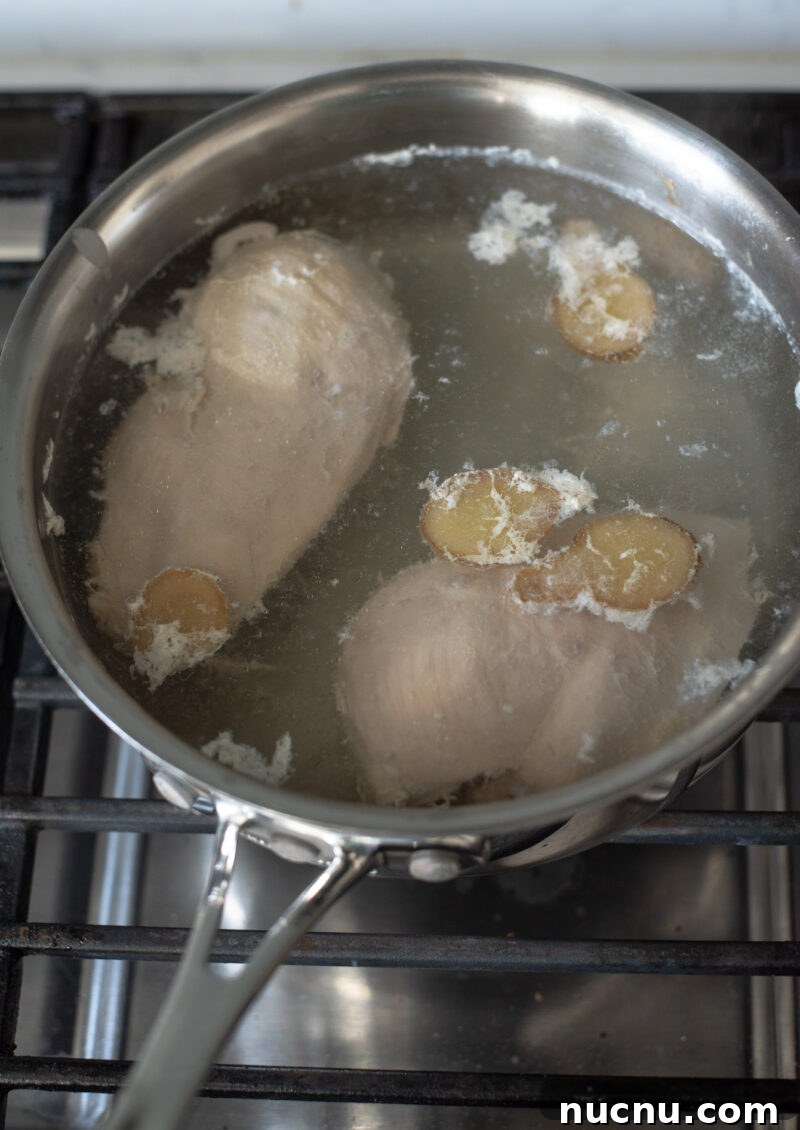 Authentic Vietnamese Shredded Chicken Salad (Gà Xé Phay) 6 Chicken breasts poaching with ginger for Vietnamese chicken salad