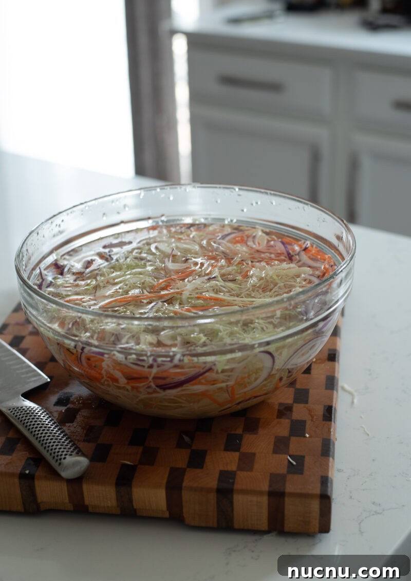 Authentic Vietnamese Shredded Chicken Salad (Gà Xé Phay) 9 Shredded cabbage, carrot, and onion soaking in cold water to stay crisp for salad.