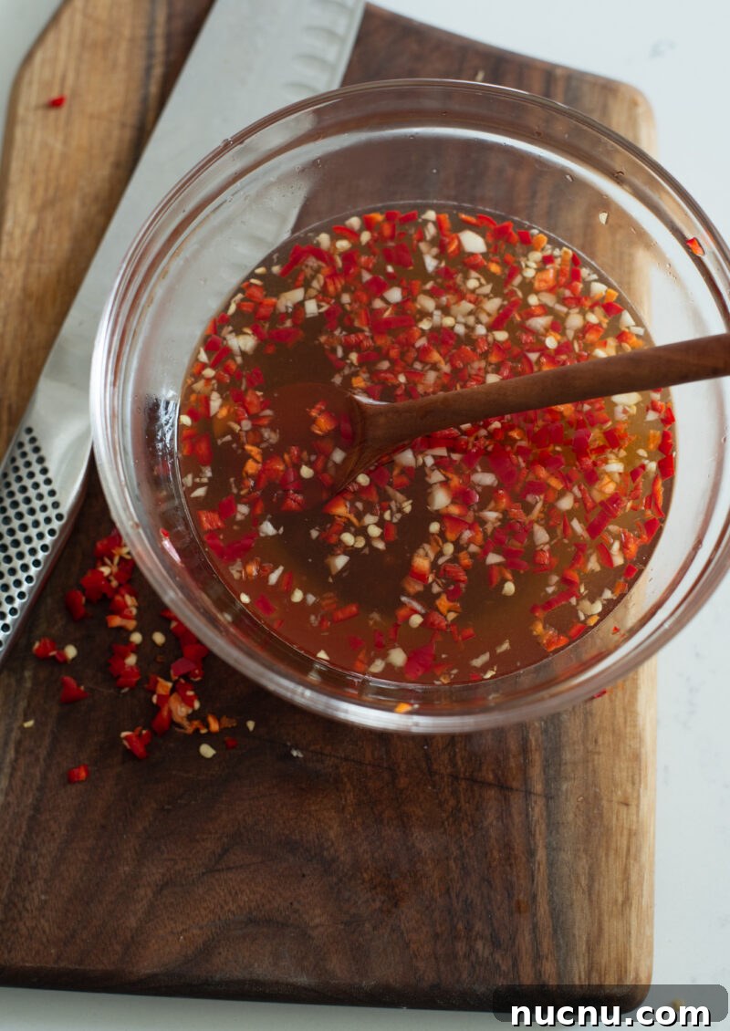 Authentic Vietnamese Shredded Chicken Salad (Gà Xé Phay) 10 Vietnamese nuoc mam dressing with fish sauce, lime, and chili in a small bowl