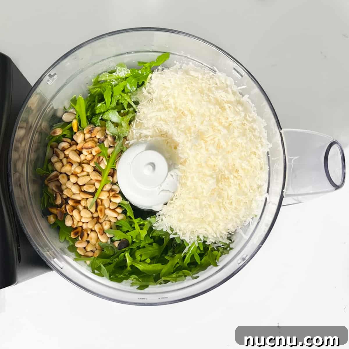 Arugula Pesto: Quick Recipe for Peppery Homemade Sauce 5 All the ingredients in a food processor.