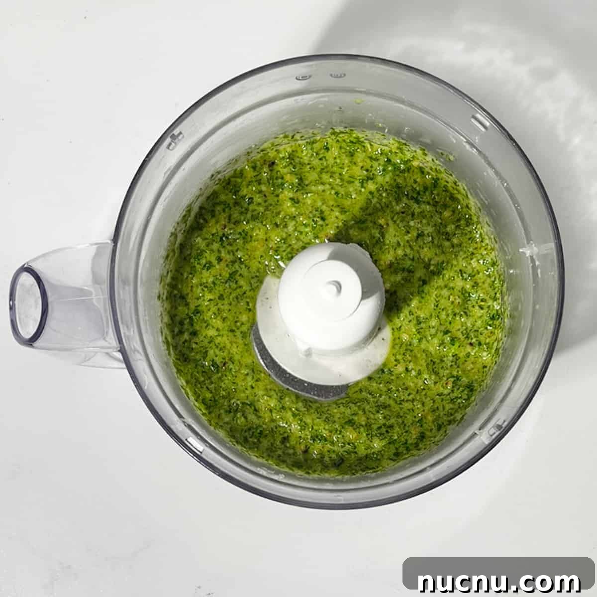 Arugula Pesto: Quick Recipe for Peppery Homemade Sauce 6 Blended rocket pesto in a food processor.
