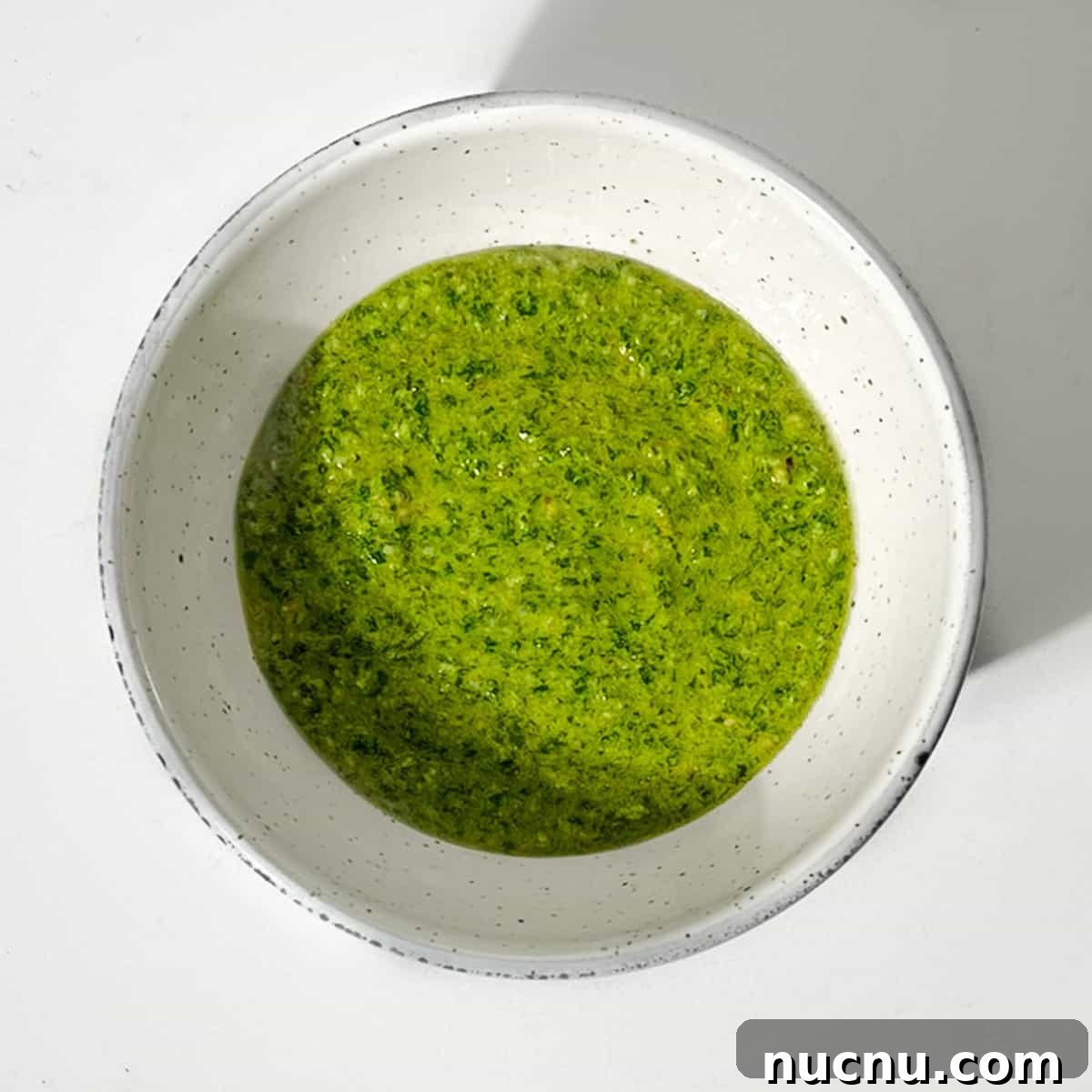 Arugula Pesto: Quick Recipe for Peppery Homemade Sauce 7 Rocket pesto in a small bowl.
