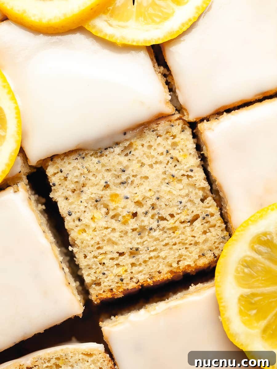 Zesty Gluten-Free Lemon Desserts You'll Love 2 gluten free lemon poppyseed cake topped with a lemon glaze and lemon slices, a gluten free lemon desserts