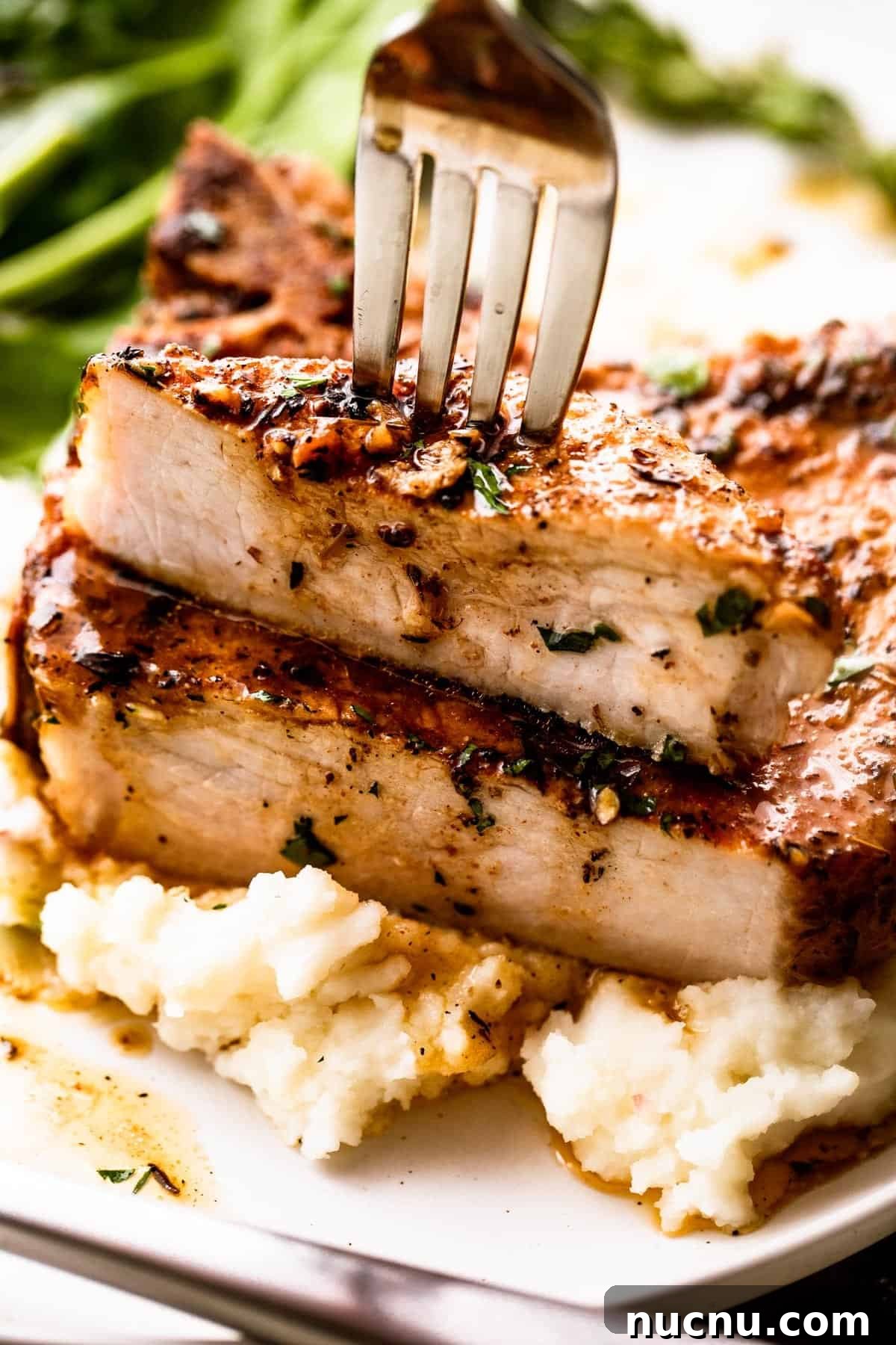 24 Quick Weeknight Dinners Ready in 30 Minutes or Less 2 fork stabbing through a halved pork chop set on a bed of mashed potatoes