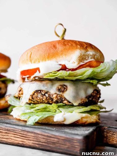 black bean burger set on a wooden chopping board with a toothpick inserted through the center of the burger