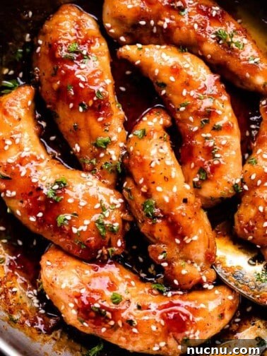 overhead shot of honey garlic chicken tenders in a skillet
