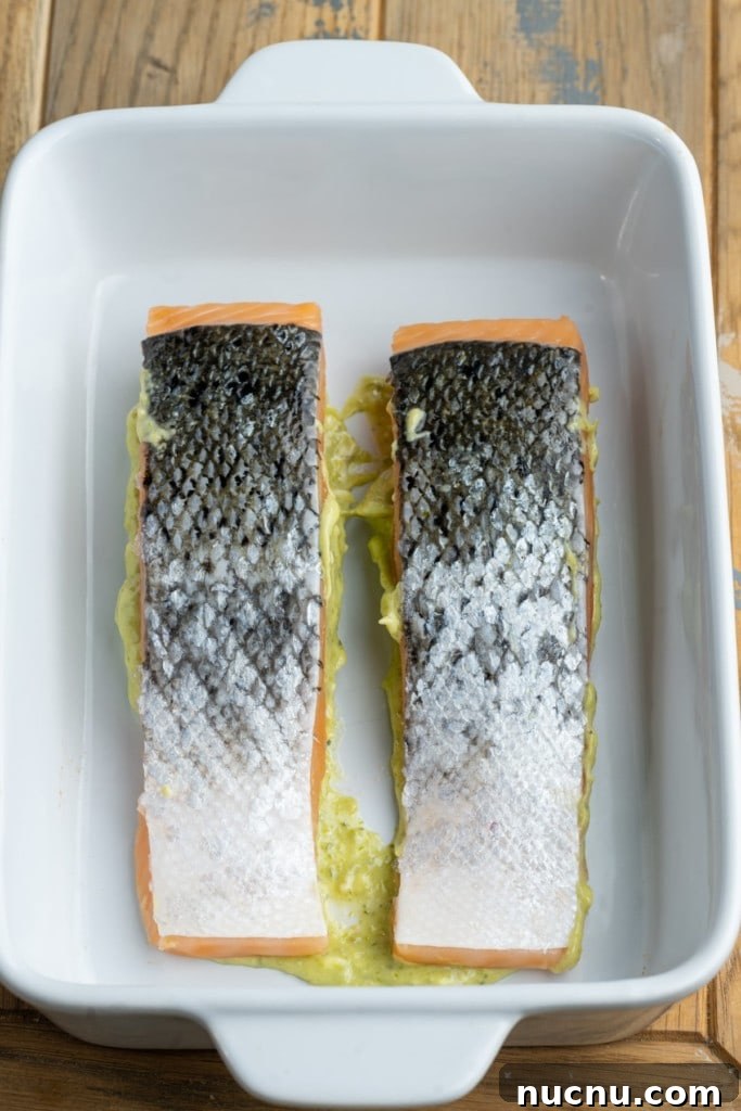 Pesto Butter Salmon with 3 Ingredients — Quick Weeknight Recipe 7 placing pesto butter almon face down in casserole dish