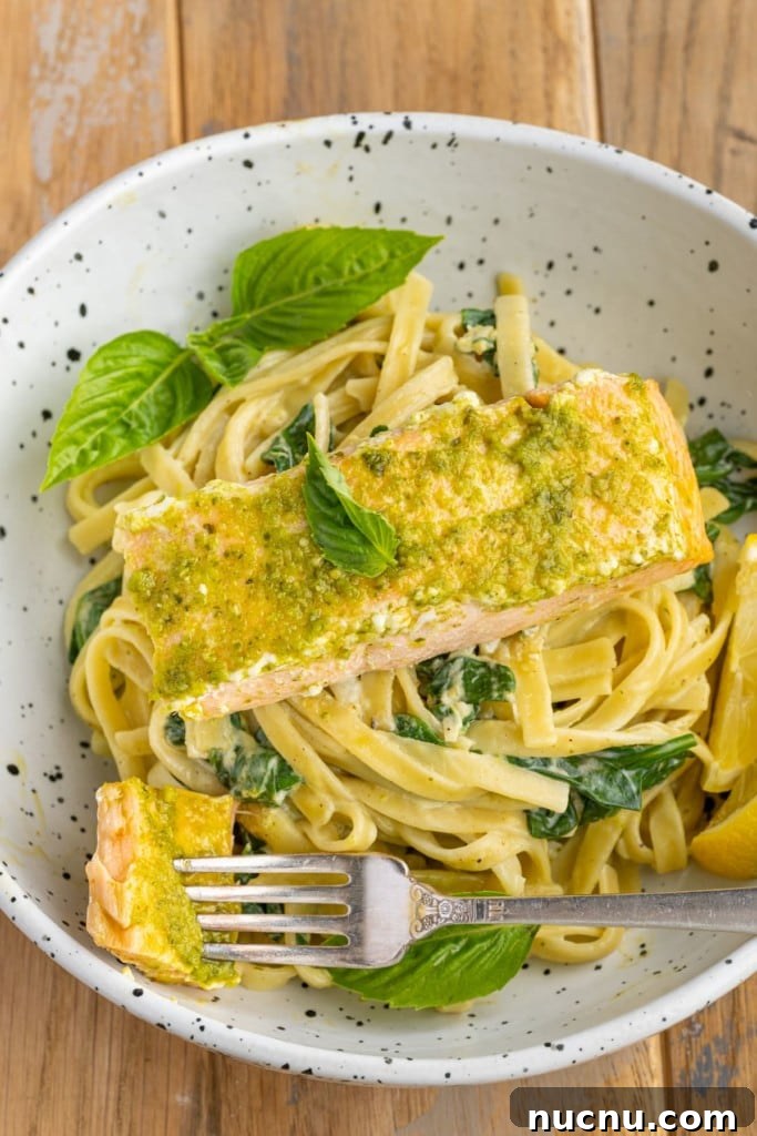 Pesto Butter Salmon with 3 Ingredients — Quick Weeknight Recipe 9 close up of pesto butter salmon over pasta with a forkful