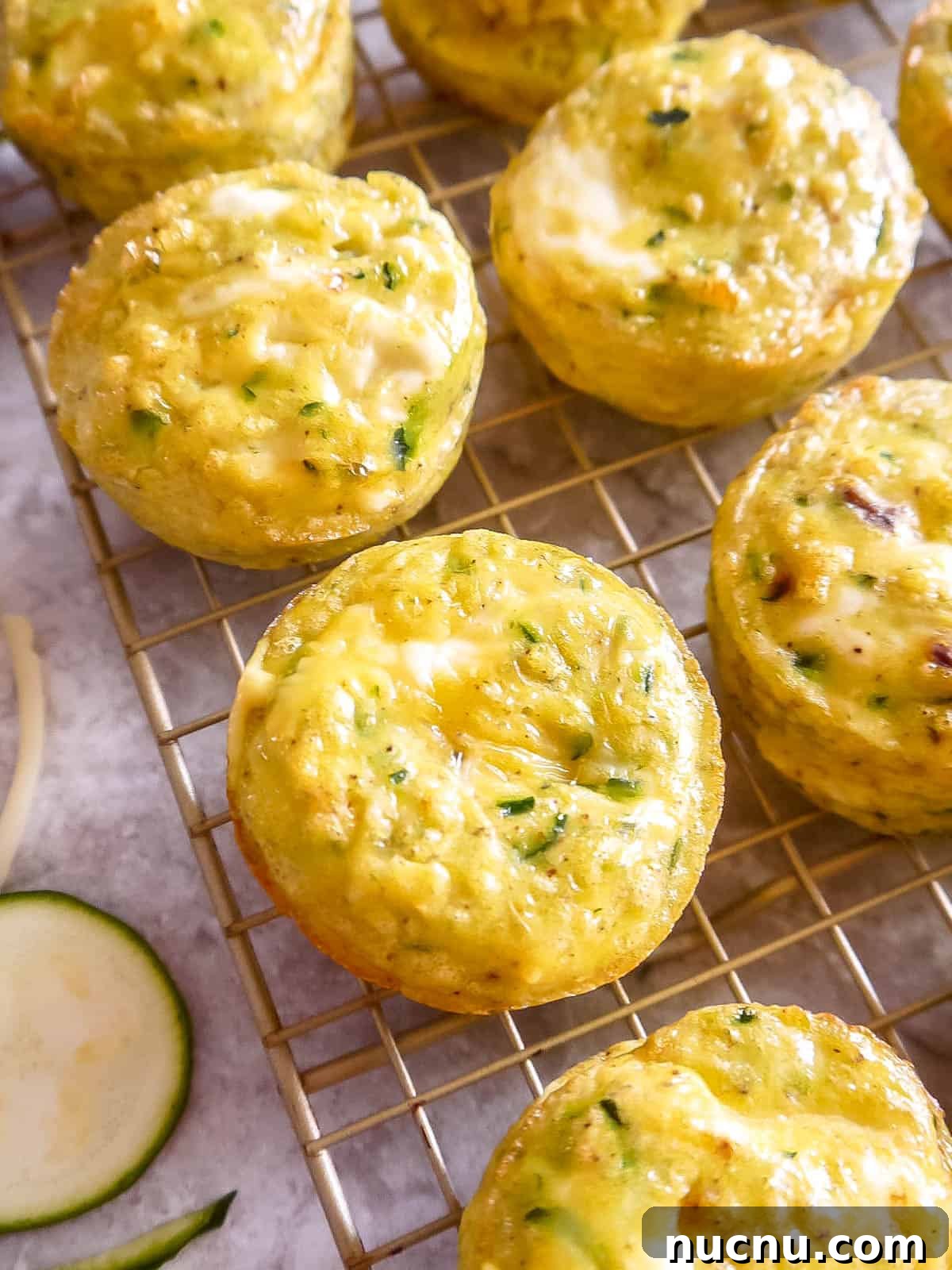 Zucchini Egg Muffin Cups: Protein-Packed Breakfast Bites 2 Healthy Zucchini Egg Muffin Cups cooling on a wire rack.