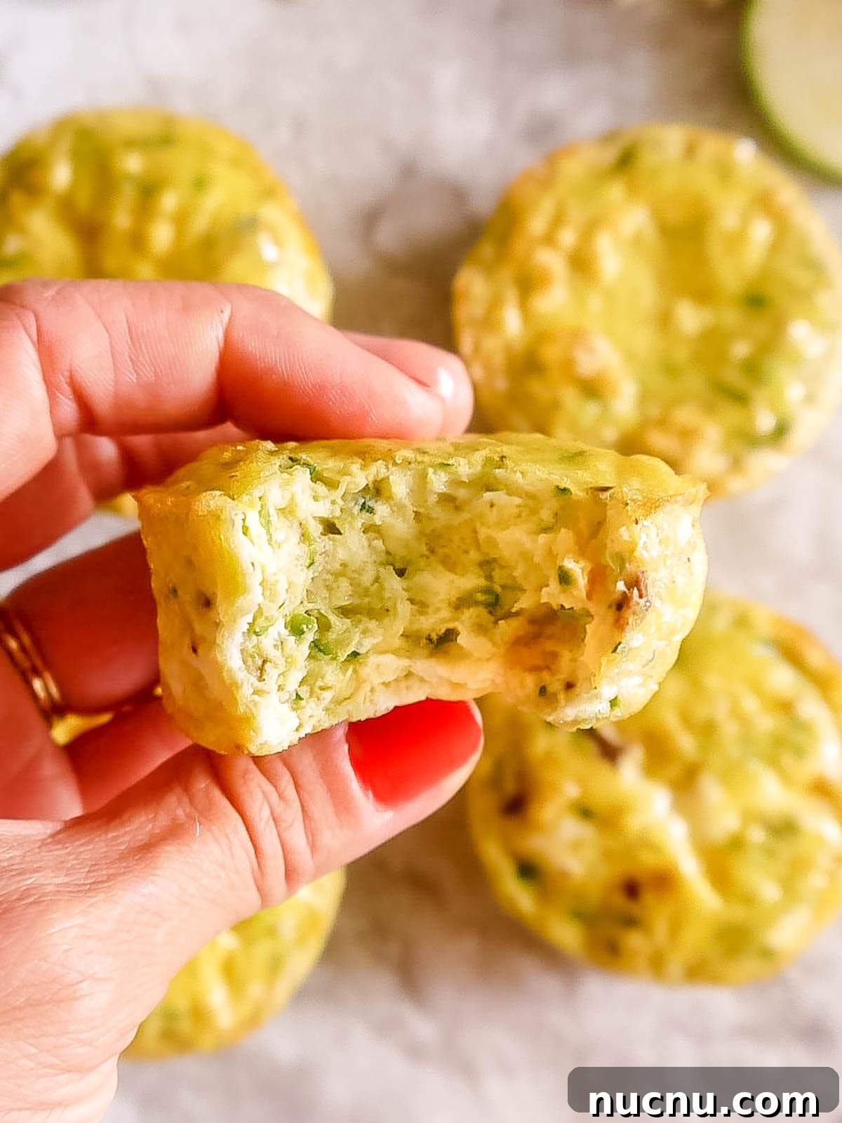 Zucchini Egg Muffin Cups: Protein-Packed Breakfast Bites 12 A bite taken out of zucchini egg muffins.