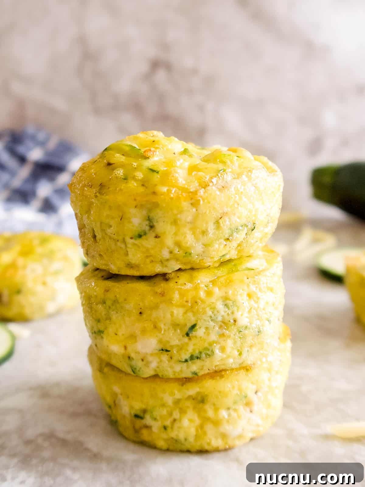 Zucchini Egg Muffin Cups: Protein-Packed Breakfast Bites 13 Zucchini egg muffins stacked on top of each other.