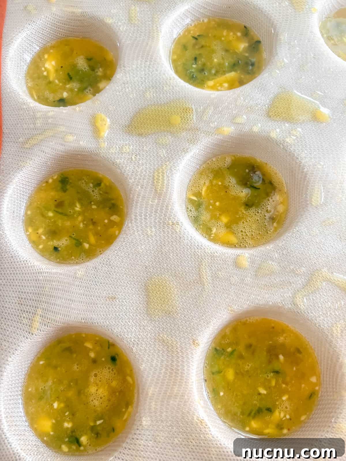 Zucchini Egg Muffin Cups: Protein-Packed Breakfast Bites 10 Egg mixture in silicone muffin tin.