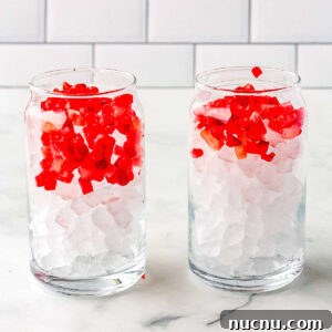 Strawberry Breeze Cocktail Copycat Recipe: Refreshing Homemade Drink 12 Frozen chopped strawberries added to thge glasses.