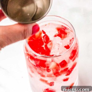 Strawberry Breeze Cocktail Copycat Recipe: Refreshing Homemade Drink 14 Vanilla and coconut syrup being poured into the glasses.