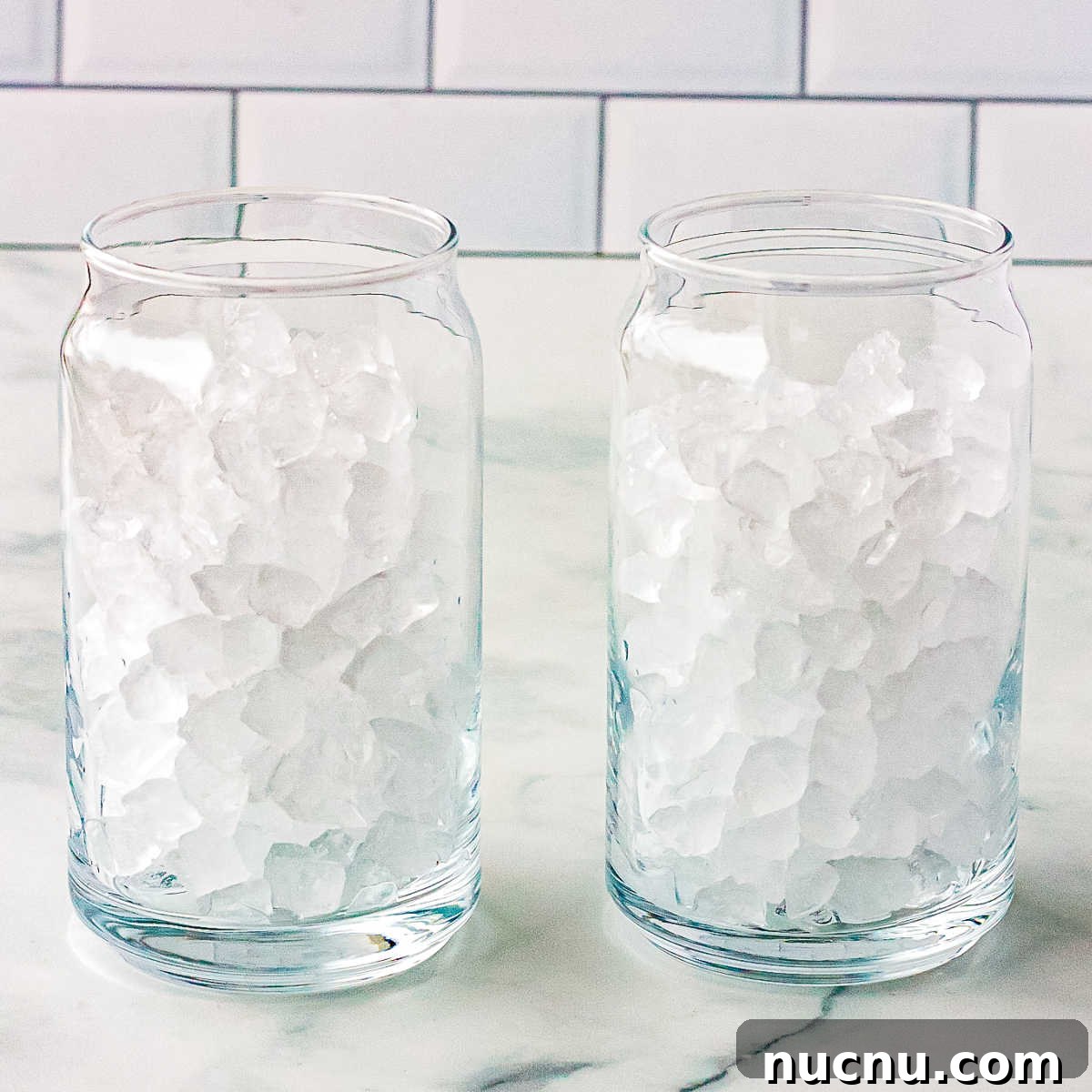Strawberry Breeze Cocktail Copycat Recipe: Refreshing Homemade Drink 4 Pebble ice in two clear drinking glasses.