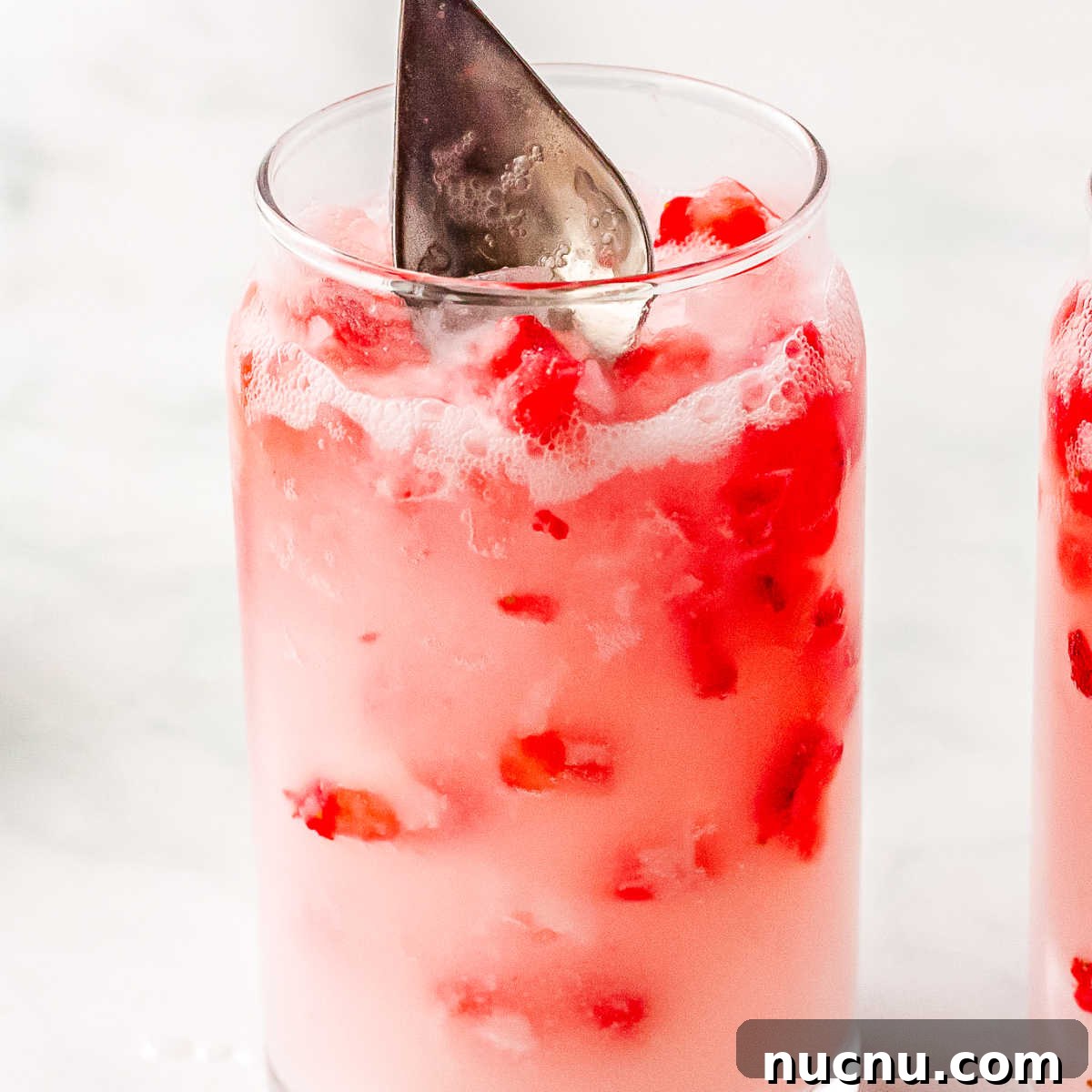Strawberry Breeze Cocktail Copycat Recipe: Refreshing Homemade Drink 8 Coconut creme and strawberry puree stired in the glasses.