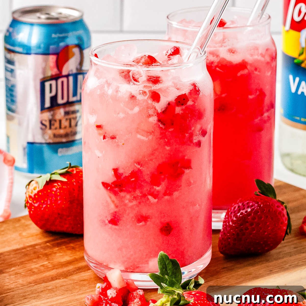 Strawberry Breeze Cocktail Copycat Recipe: Refreshing Homemade Drink 9 The finished strawberry breeze drinks on a wooden cutting board.