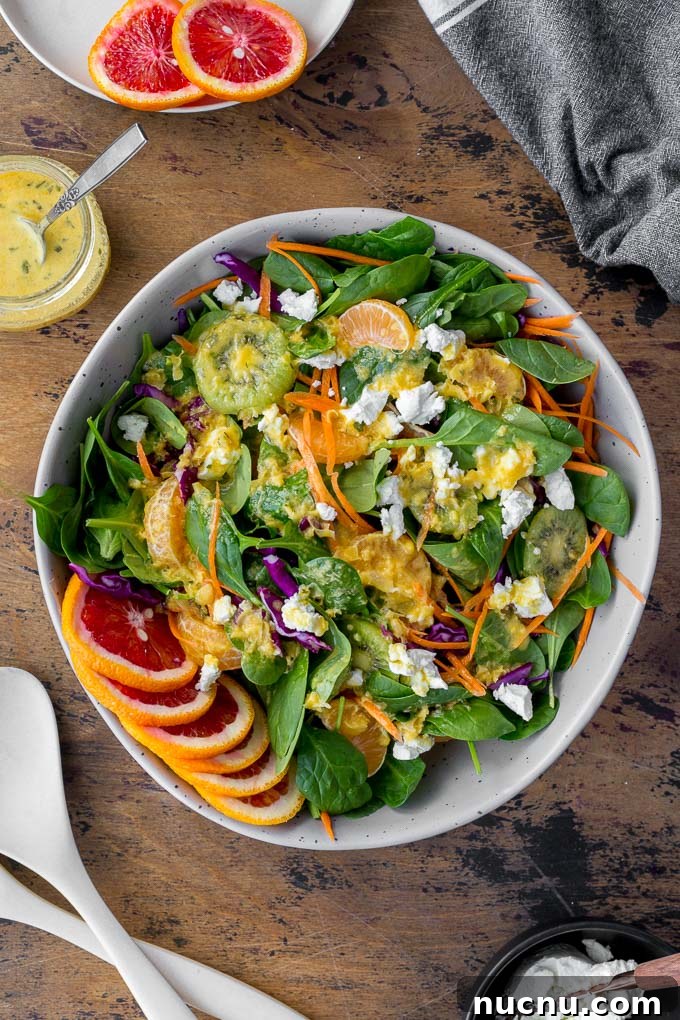 Winter Citrus Salad with Honey Dressing and Toasted Almonds 2 Overhead view of Winter Salad in a large grey bowl and topped with Citrus Honey Dressing.