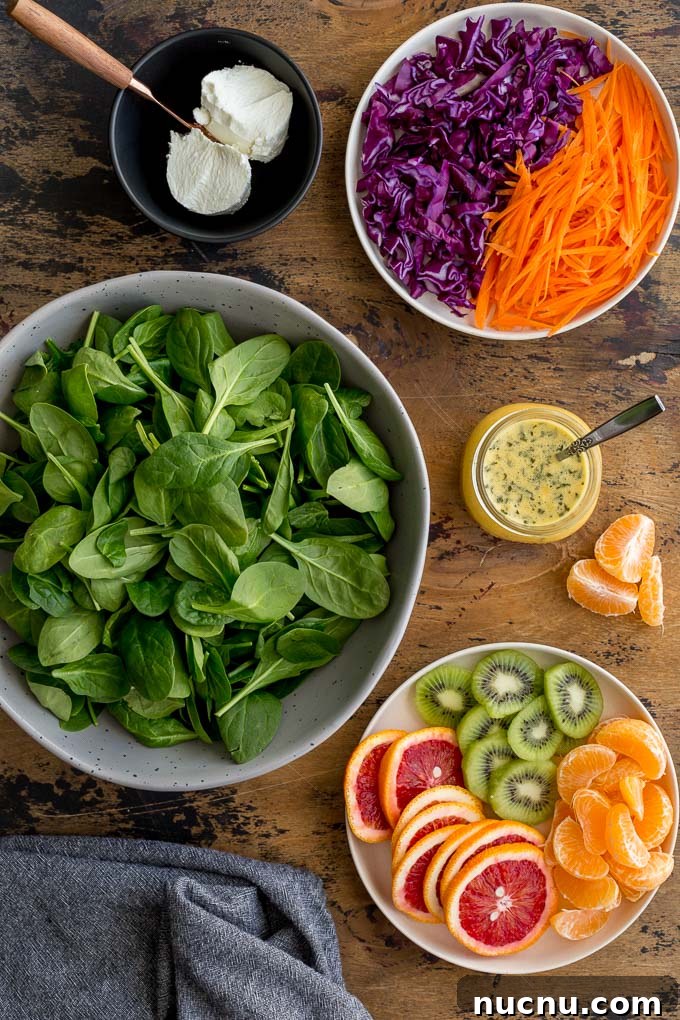 Winter Citrus Salad with Honey Dressing and Toasted Almonds 3 Ingredients to make Winter Salad arranged on a wooden surface.