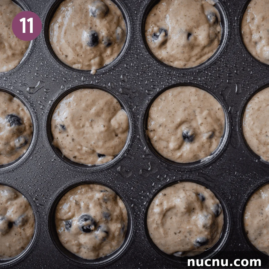 Vegan Blueberry Muffins Recipe: Moist, Fluffy, Simple to Make 11 vegan blueberry muffin batter scooped all the way to the top of muffin tins.