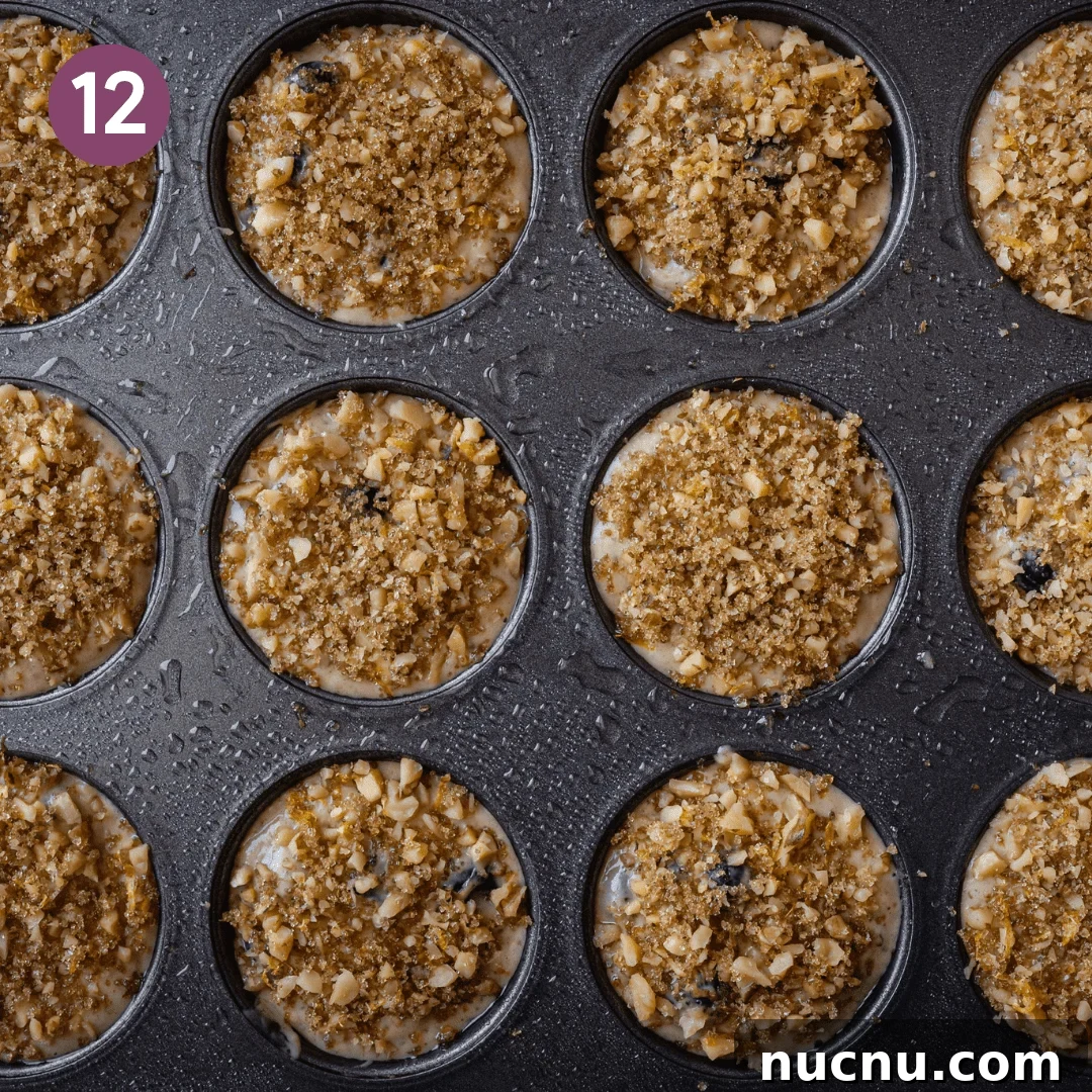 Vegan Blueberry Muffins Recipe: Moist, Fluffy, Simple to Make 12 crumble topping on top of muffins in muffin tin.