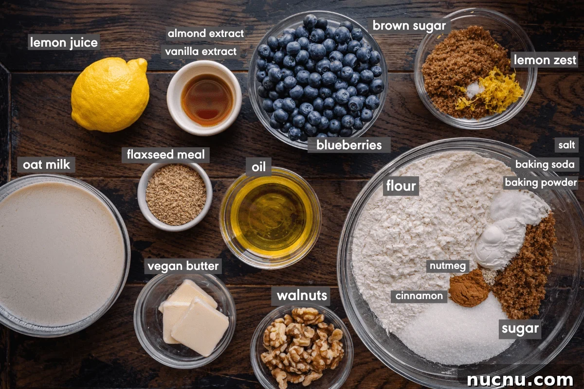 Vegan Blueberry Muffins Recipe: Moist, Fluffy, Simple to Make 4 labeled ingredients for vegan blueberry muffins on wooden board.