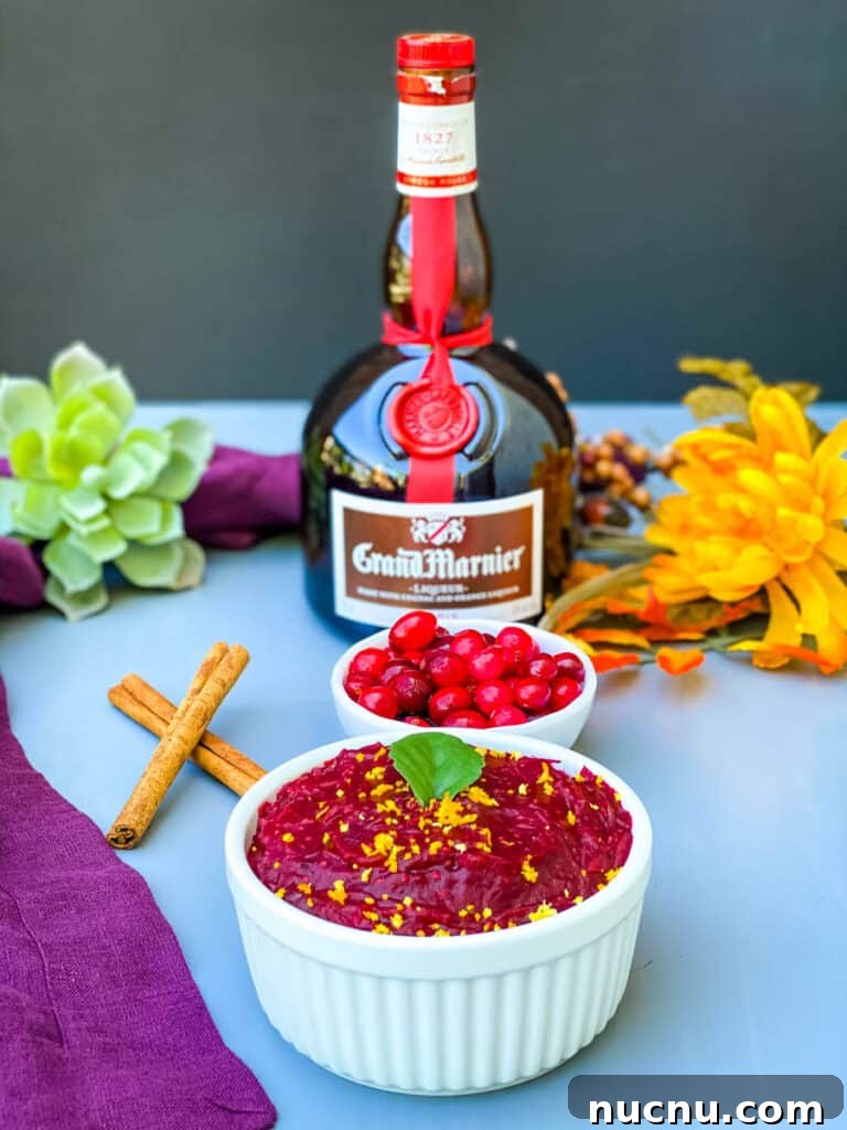 Grand Marnier Cranberry Sauce Recipe for Holiday Dinners 2 Grand Marnier cranberry sauce in a white bowl with a bottle of Grand Marnier