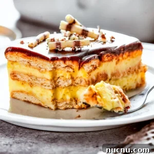 Decadent Chocolate Éclair Cake Recipe for Dessert Lovers 3 A slice of chocolate eclair cake on a plate, with a fork on the plate with a bite of cake.