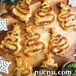 Pesto puff pastry Christmas trees on a wooden board.