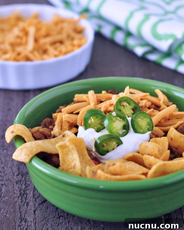 Frito Pie Frito Pie (chili in a green bowl, topped with Frito chips, cheese, jalapenos, dairy free sour cream)